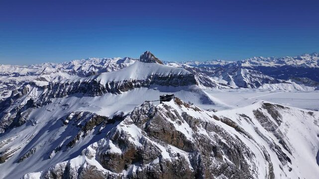 Panoramic Aerial View of Glacier 3000 with Alpine Peaks, Suspended Bridge (Peak Walk), Cable Car Lift, and Ski Resort at the Summit in Switzerland