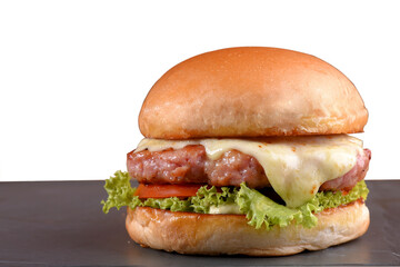 beef burger with sandwich bun salad onion and cheese fast food isolated on wooden table