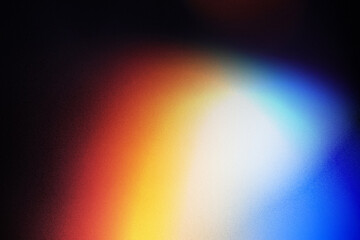 Colorful lens flare on black background.