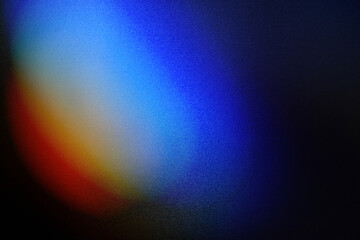 Colorful lens flare on black background.