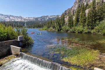 Kayakers paddle on Twin Lakes near Mammoth Lakes, California, USA. The lake is surrounded by...
