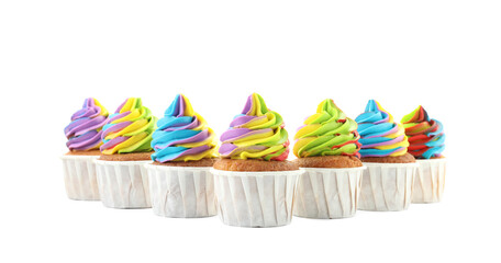Tasty cupcakes with colorful cream isolated on white
