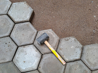 Installation of hexagon paving. Construction tools and details, paving installing with rubber...