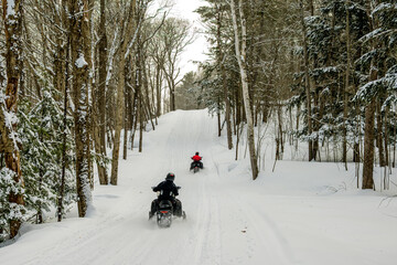 Snow machine riders on a decicated snowmobile trail shot in Parry Sound Ontario mid-winter © Michael Connor Photo