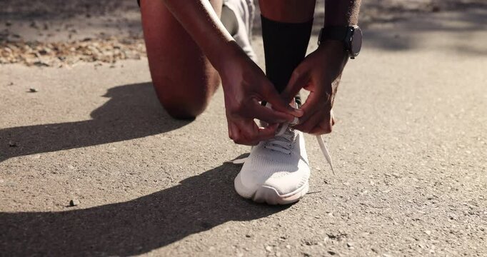 Man, hands and tie laces for training preparation, outdoor and active shoes for running. Fingers, road and person with legs for exercise in countryside, sneakers and getting ready for workout start