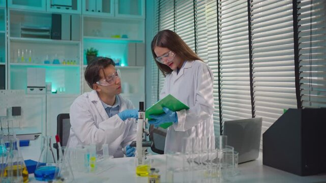 Asian male and female scientis work together in the research laboratory.