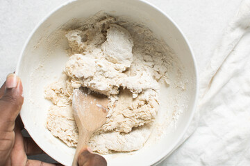 Overhead view of hot cross bun dough being mixed, process of making hot cross buns