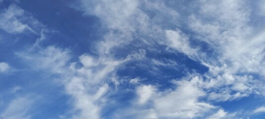 sky with swirling clouds in various shades of blue and white, creating a dynamic and captivating visual effect that evokes a sense of wonder.