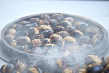 Roasting chestnuts in a traditional street vendor setup