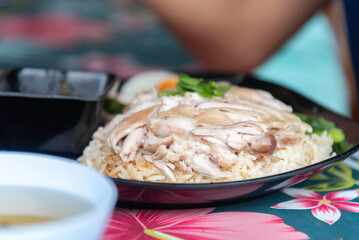 Hainanese Chicken rice or Steamed rice topped with chicken.
