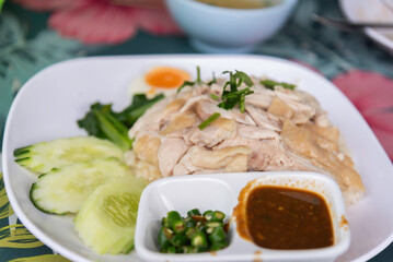 Hainanese Chicken rice or Steamed rice topped with chicken.
