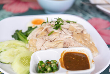 Hainanese Chicken rice or Steamed rice topped with chicken.