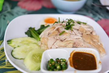 Hainanese Chicken rice or Steamed rice topped with chicken.