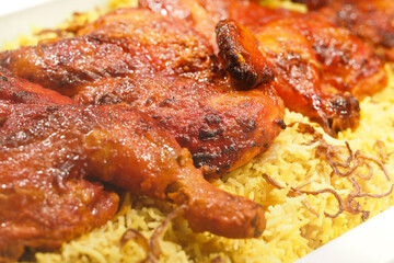 Delicious grilled chicken served over fragrant rice in a dish