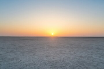 Obraz premium Stunning sunset over an empty beach with vast sandy stretch and horizon ready for reflection Generative AI