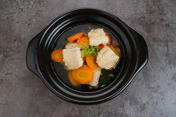 Fish soup with carrot, tomatoes and leeks. Indonesian food
