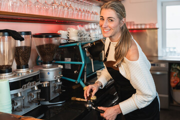 Blonde barista crafting delicious coffee with a modern espresso machine