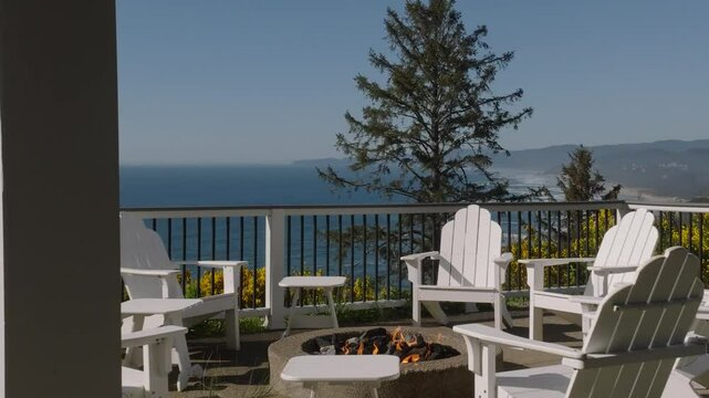Adirondack chair surrounding Fire Pit on Luxury Pacific Ocean Costal Patio Ocean View with Drone