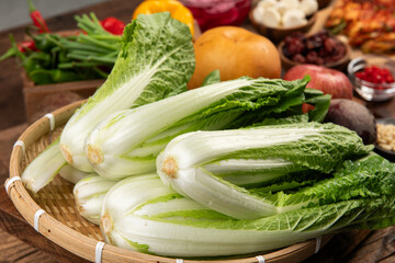 chinese cabbage in a basket on wooden table, close-up