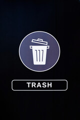 Trash sign on dark background. 