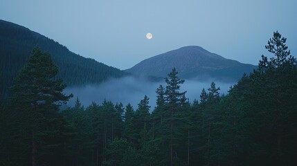 Misty mountain landscape at twilight with full moon