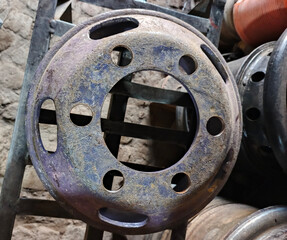 Rusty Wheel Rim with Multiple Holes in Industrial Setting