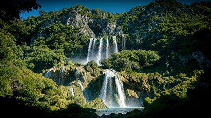 Fototapeta premium Majestic Waterfall Cascading Down Lush Green Cliff Nature Landscape Photography