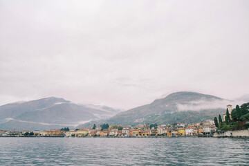 Colorful mansions on the foggy mountainous shores of Lake Como. Italy