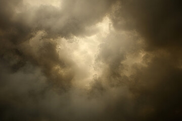 Obraz premium Dramatic sky filled with dark clouds, hinting at an impending storm, with light breaking through