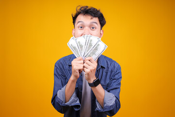 Young Asian Guy Holding Money Cash Dollar Banknotes In His Hands Over His Face