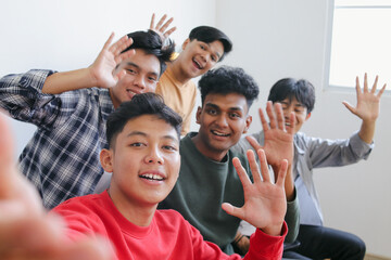 Obraz premium Young Community Of Diverse Happy Student Friends Taking Selfie And Waving Hands Together To Camera