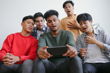 Obraz premium Group Of Multiracial People Watching Thriller Horror Movie Having Shocked Reaction
