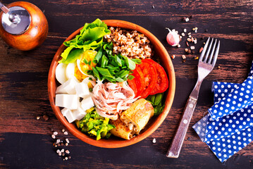 Delicious healthy breakfasts, buckwheat with boiled egg and meat and cheese on plate