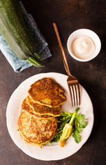 Potato pancakes with zucchini on white plate