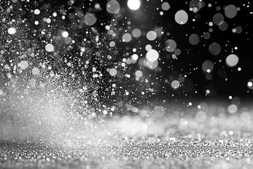 Abstract black and white image of sparkling water droplets creating a dynamic, dreamy atmosphere