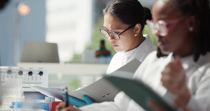 Women, documents and research in laboratory, science or problem solving at pharmaceutical company. People, group and feedback with paperwork, clinical study or medical project for vaccine development
