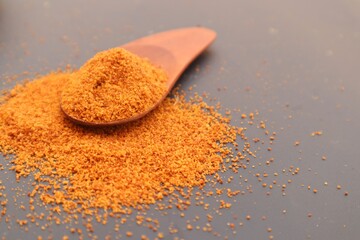 Palm sugar, or brown sugar, or kawung sugar (Arenga pinnata), close up, on a black background.