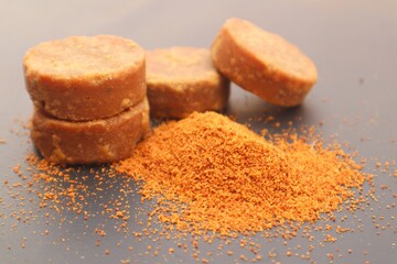 Palm sugar, or brown sugar, or kawung sugar (Arenga pinnata), close up, on a black background.