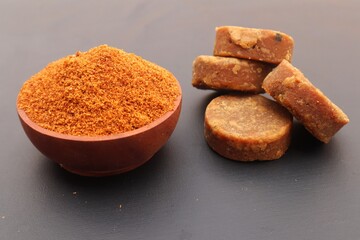 Palm sugar, or brown sugar, or kawung sugar (Arenga pinnata), close up, on a black background.