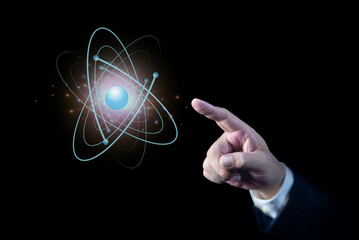Businessman hand pointing creative atom. Nuclear fusion concept, endless energy, cheap electricity,...