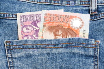 Ghanaian Cedi in the pocket of blue jeans
