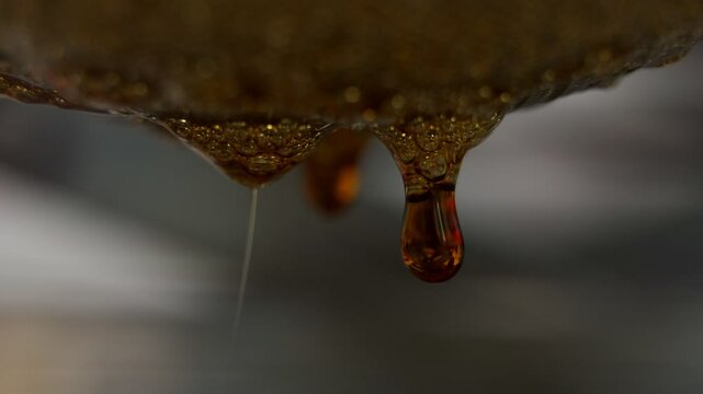 Cannabis Live Resin Sauce Extract Dripping From Strainer