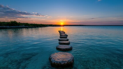 Serene sunset over calm water with stepping stones path.