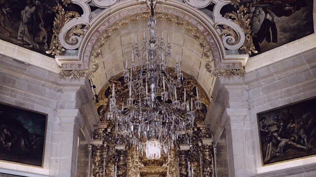Lavish baroque church interior with crystal chandelier and gilded altar details