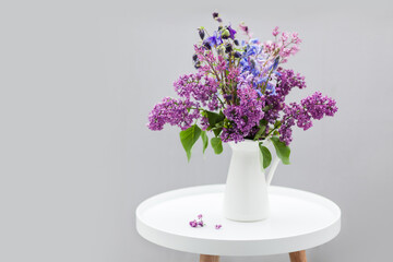 Spring bouquet of lilac. Blooming flowers from home garden. Still life on decorative table....