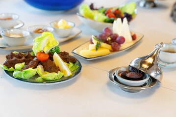 Turkish style Ramadan Iftar table. Raw meatballs, cig kofte from traditional Turkish cuisine. 