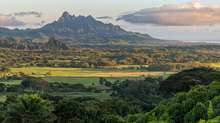 Naklejka premium Panoramic View of Lush Green Valley with Distant Mountains at Sunset