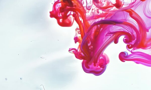 pink ink color goes into the water with slow motions