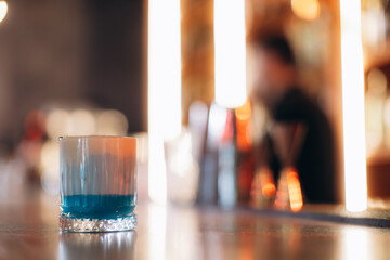 Colorful Cocktail Glass on Bar Counter in Dimly Lit Ambient Lounge