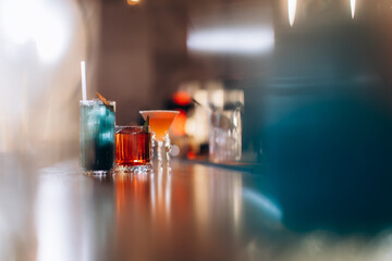 Assorted Colorful Cocktails on a Stylish Bar Counter with Blurred Background